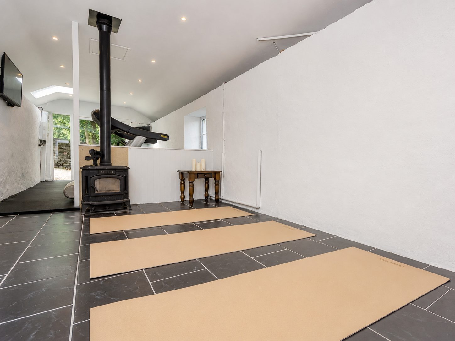 Wellness studio with professional rubber flooring and wood stove
